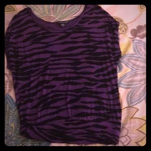 This is a cute purple top with black stripes